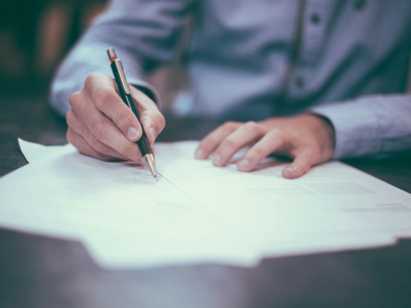 Arizona home closing with escrow documents and keys on a table